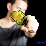 A man holds a broken bottle in front of him